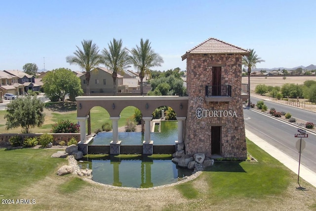 exterior space featuring a lawn and a water view