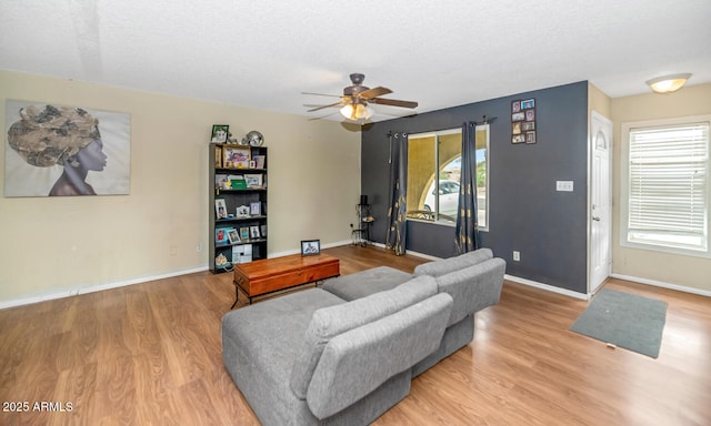 4417 W Sandra Cir, Glendale, AZ 85308 - living room with a wealth of natural light, a ceiling fan, wood finished floors, and baseboards