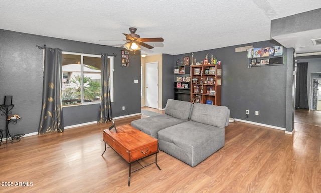 4417 W Sandra Cir, Glendale, AZ 85308 - living area with baseboards, a ceiling fan, wood finished floors, and a textured ceiling