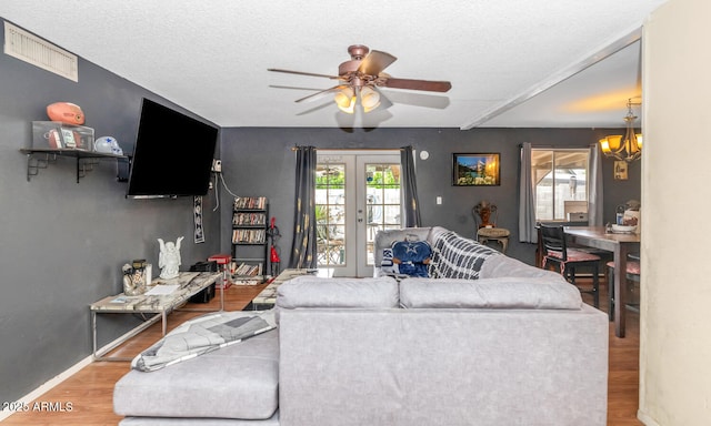 4417 W Sandra Cir, Glendale, AZ 85308 - living room with plenty of natural light, visible vents, ceiling fan with notable chandelier, and wood finished floors