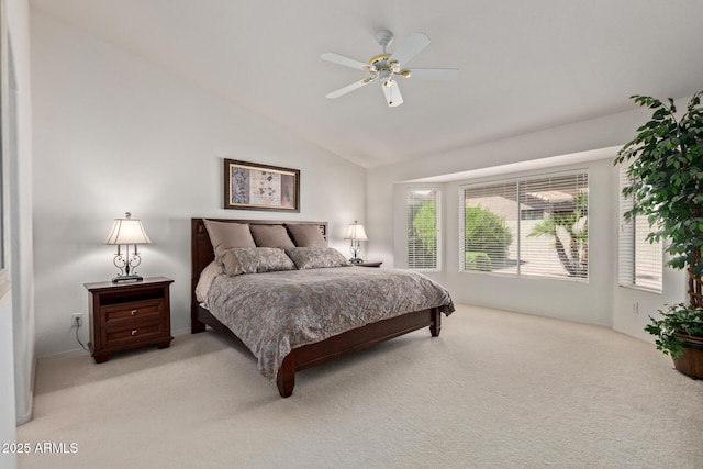 bedroom with light carpet, vaulted ceiling, and a ceiling fan
