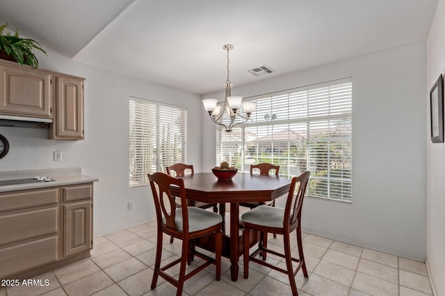 dining space with a chandelier and light tile patterned floors