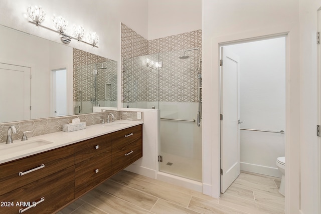 bathroom with vanity, toilet, hardwood / wood-style flooring, and walk in shower