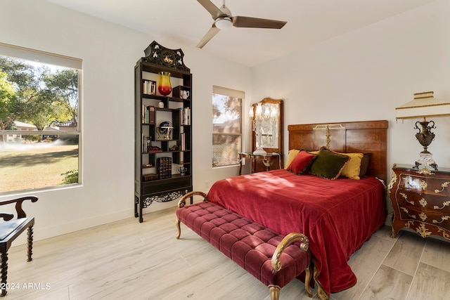 bedroom with light hardwood / wood-style floors, multiple windows, and ceiling fan