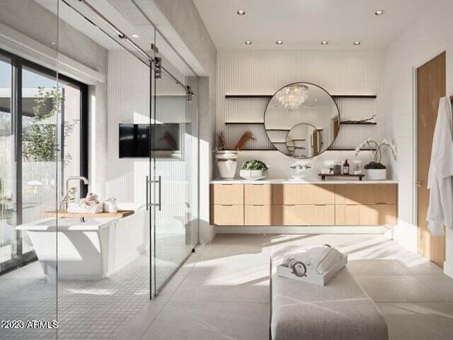 bathroom featuring a washtub and vanity