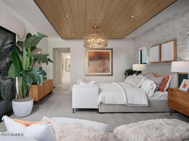 bedroom featuring wooden ceiling and a notable chandelier