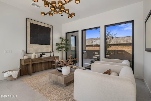 tiled living room with a chandelier