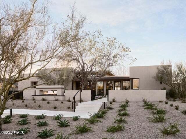 rear view of property featuring a sunroom