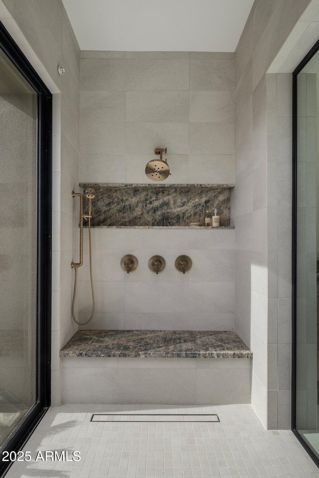 bathroom with tiled shower