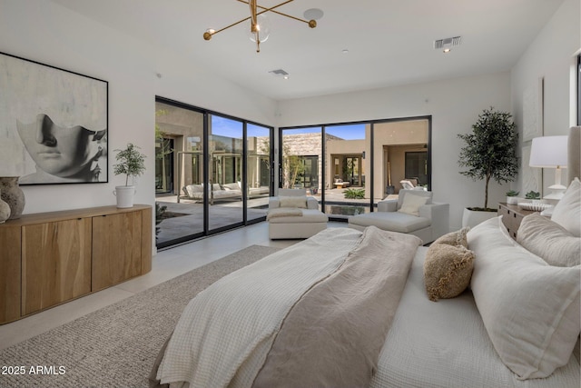 bedroom with access to outside and an inviting chandelier