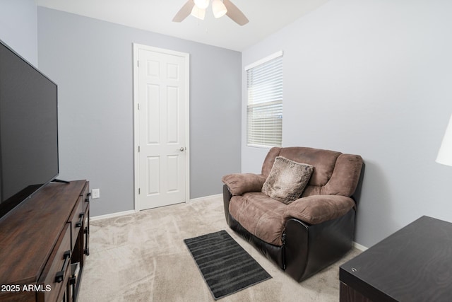 living area with ceiling fan and light carpet