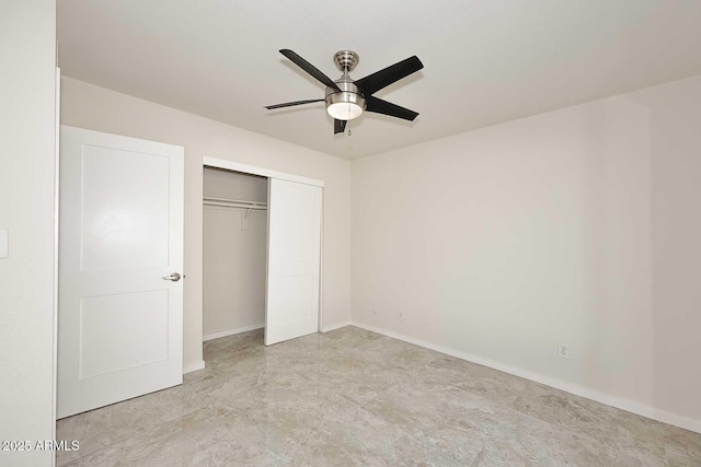 unfurnished bedroom with ceiling fan and a closet