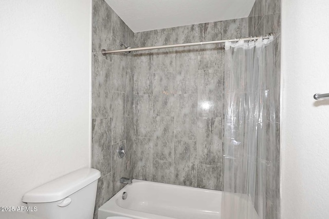 bathroom featuring shower / tub combo and toilet