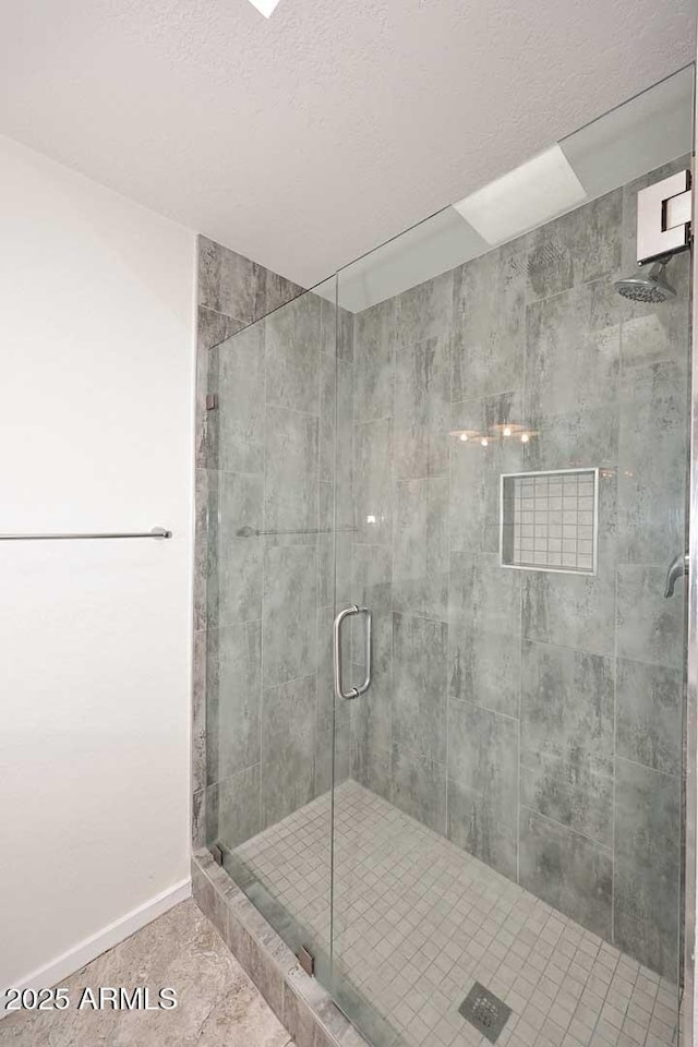 bathroom with tile patterned floors and a shower with shower door