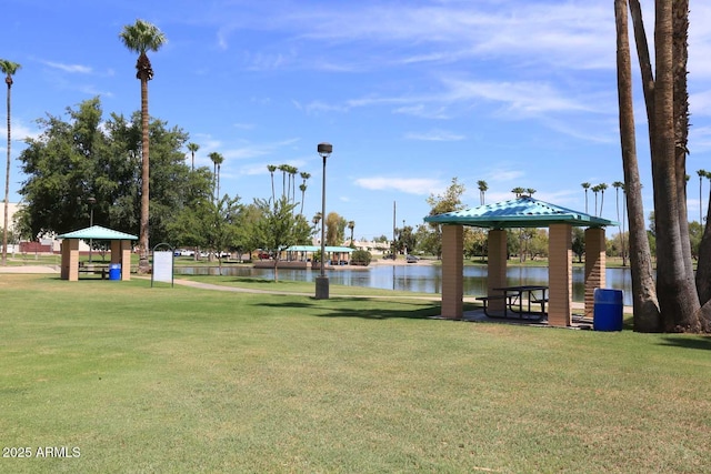 view of home's community with a gazebo, a water view, and a yard