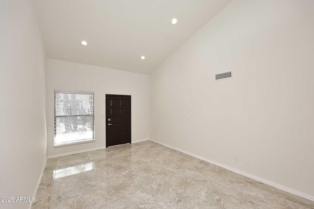 empty room featuring a high ceiling