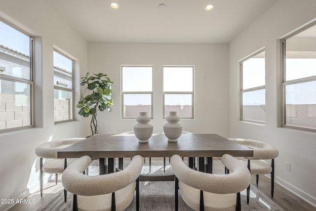 dining space with recessed lighting, baseboards, and dark wood finished floors