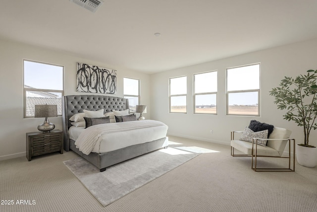 carpeted bedroom with visible vents and baseboards