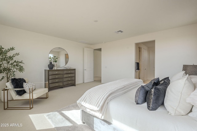 carpeted bedroom featuring visible vents