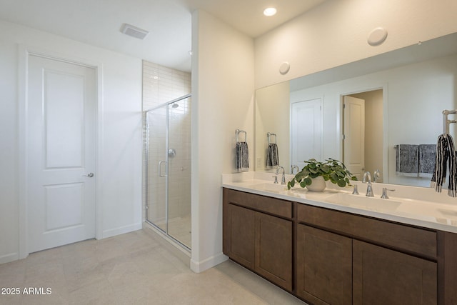 full bathroom with a sink, visible vents, a stall shower, and double vanity