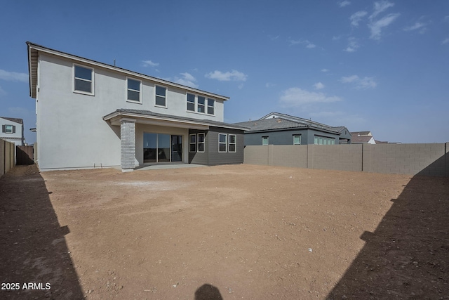 back of property with a fenced backyard