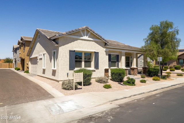 324 N 56th Pl, Mesa, AZ 85205 - view of front of home featuring an attached garage, stucco siding, and driveway