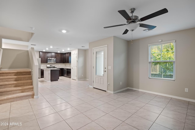 unfurnished living room with light tile patterned floors and ceiling fan