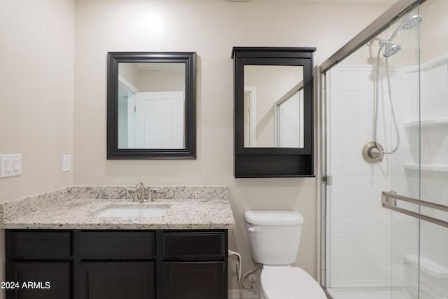 bathroom with vanity, toilet, and an enclosed shower