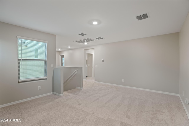 empty room featuring light colored carpet