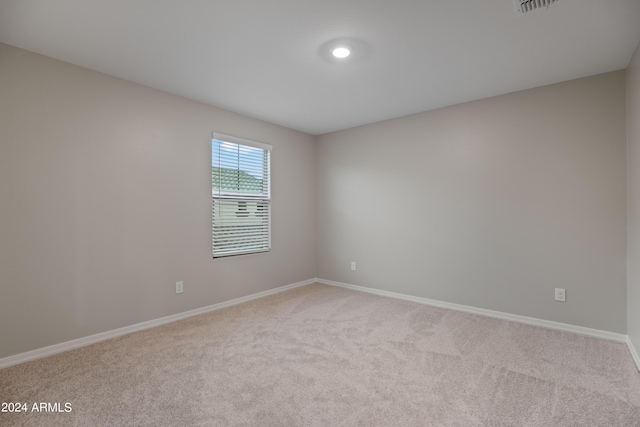 unfurnished room featuring light carpet