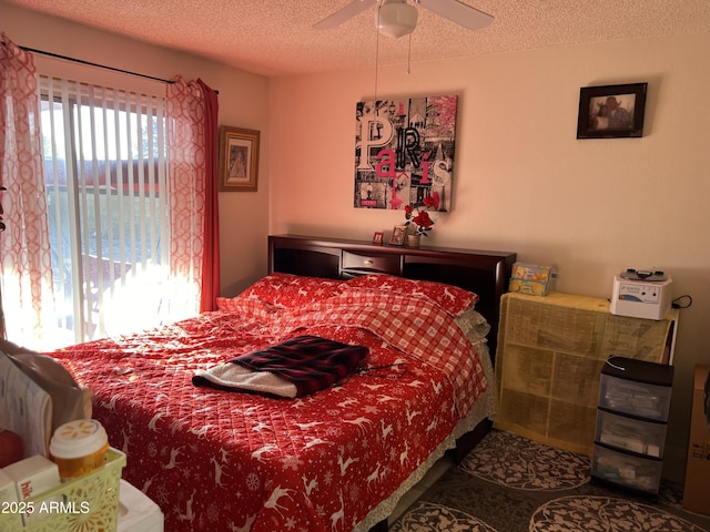 bedroom with ceiling fan and a textured ceiling