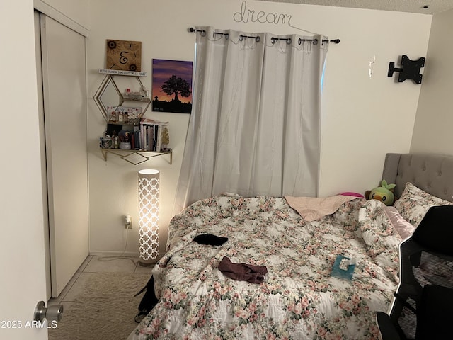 tiled bedroom featuring a closet