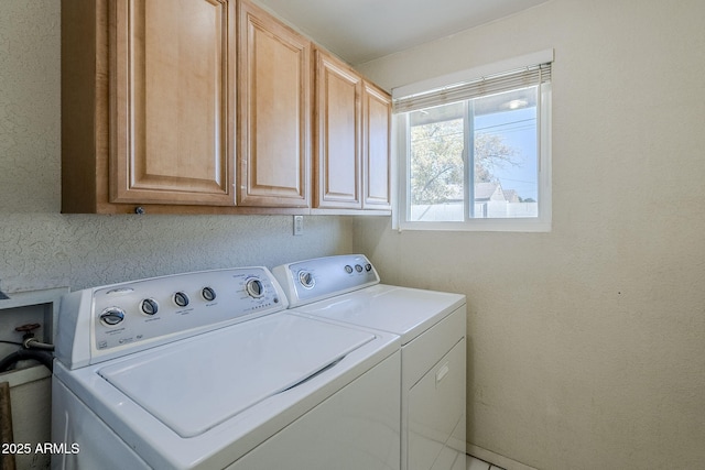 washroom with cabinets and independent washer and dryer