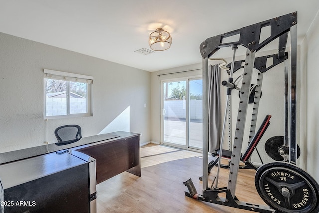 workout area with light wood-type flooring