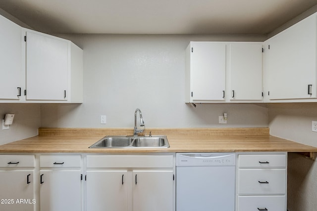 kitchen with white dishwasher, sink, and white cabinetry