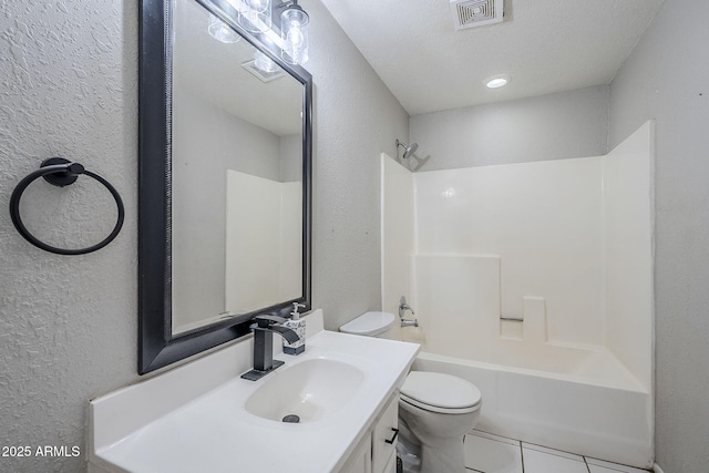 full bathroom with toilet,  shower combination, tile patterned floors, a textured ceiling, and vanity