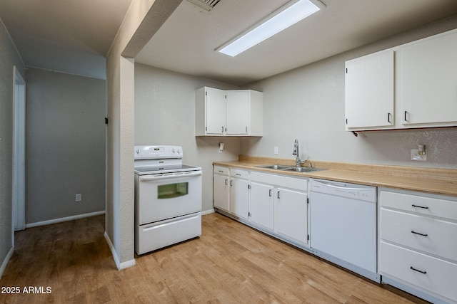 kitchen featuring sink, white appliances, white cabinets, and light wood-type flooring