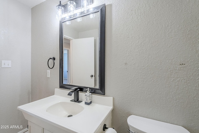 bathroom with toilet and vanity