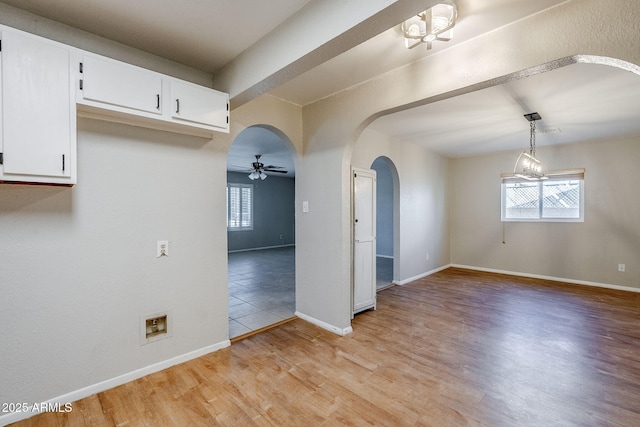 empty room with ceiling fan and light wood-type flooring