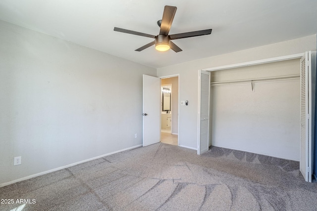 unfurnished bedroom with ceiling fan, a closet, and carpet flooring