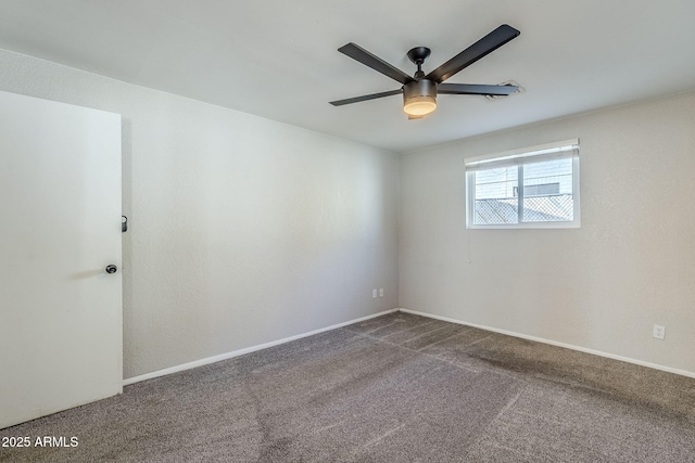 unfurnished room with ceiling fan and carpet flooring