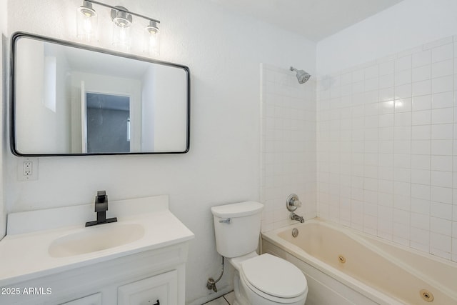 full bathroom featuring toilet, tiled shower / bath, and vanity