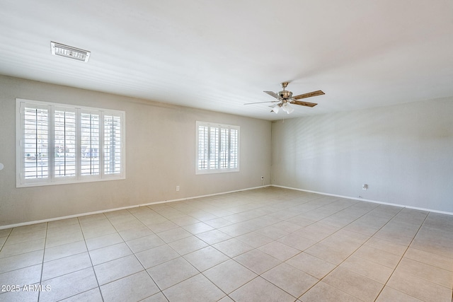 unfurnished room with ceiling fan, light tile patterned floors, and a healthy amount of sunlight