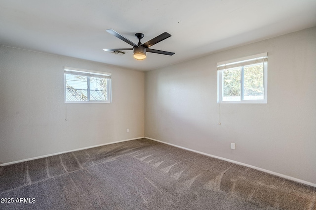 carpeted spare room with ceiling fan