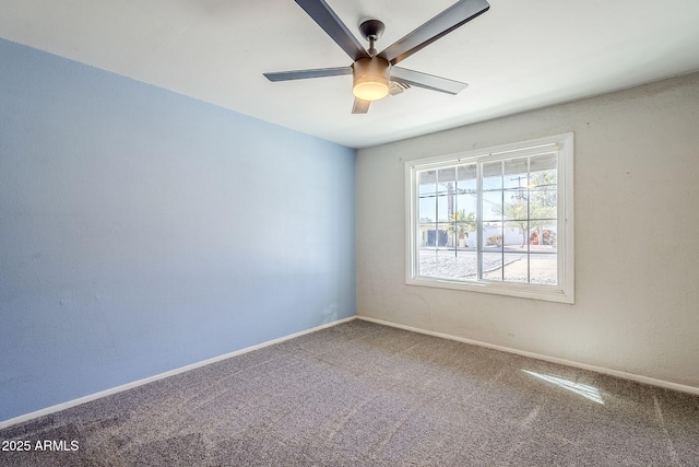 spare room featuring ceiling fan and carpet flooring