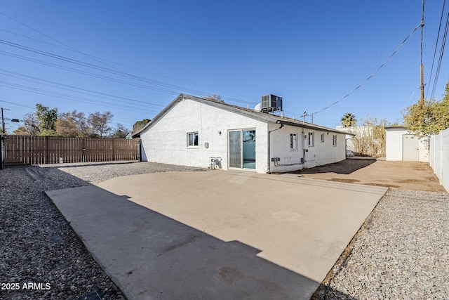 back of house with central air condition unit and a patio