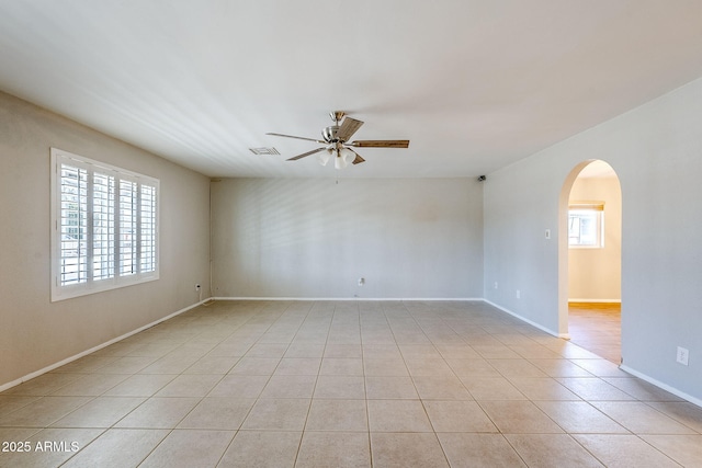 tiled empty room with ceiling fan