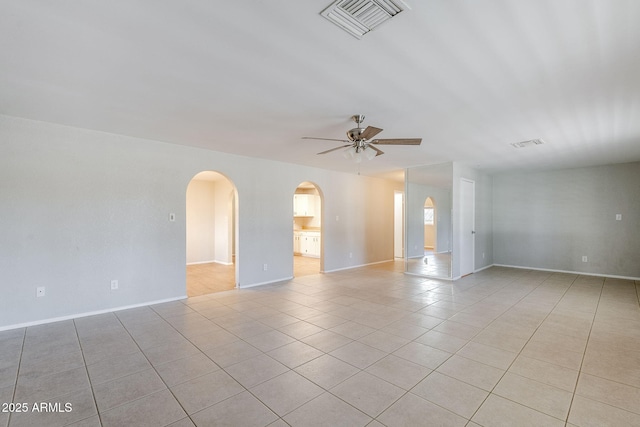 tiled spare room with ceiling fan