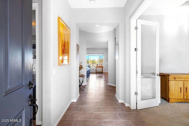 hall with french doors, visible vents, and baseboards