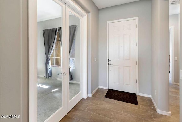 doorway to outside with baseboards and french doors